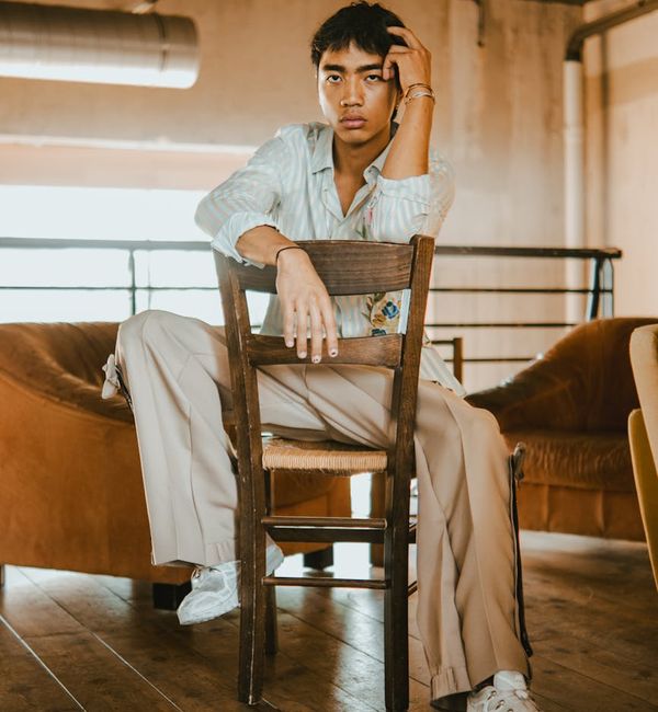 A person in a calm, balanced pose against a light, airy background.